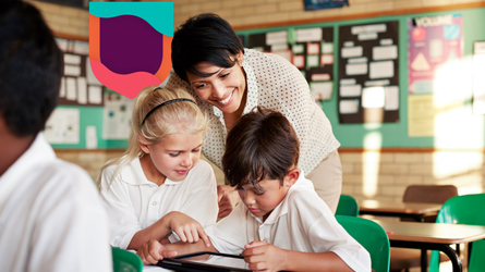 Teacher guiding students in tablet-based group learning