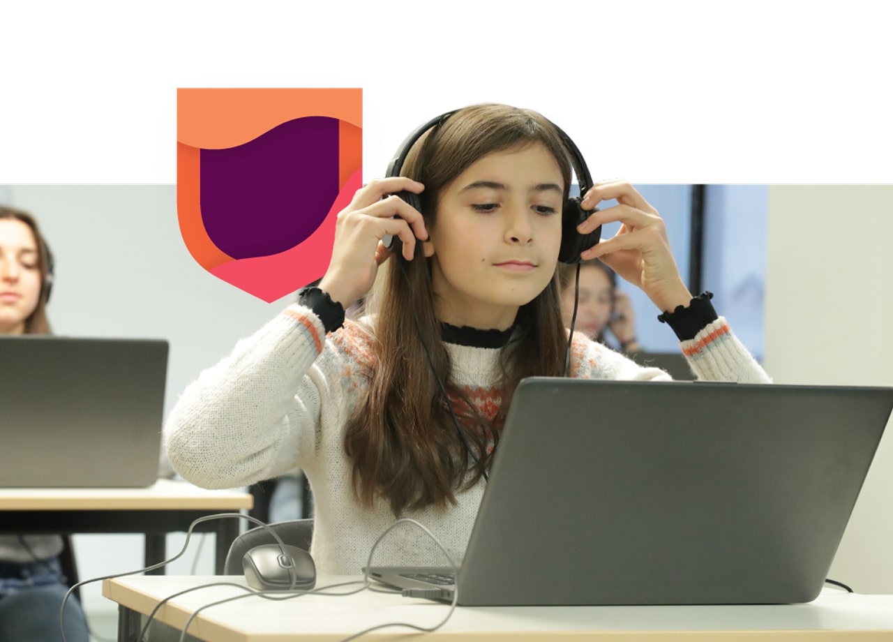 Girl with headphones using laptop.