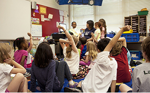 Children learning together on classroom floor.
