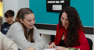 Two young women collaborating and smiling